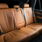 Red leather car seats, back passengers seats, modern comfortable cockpit